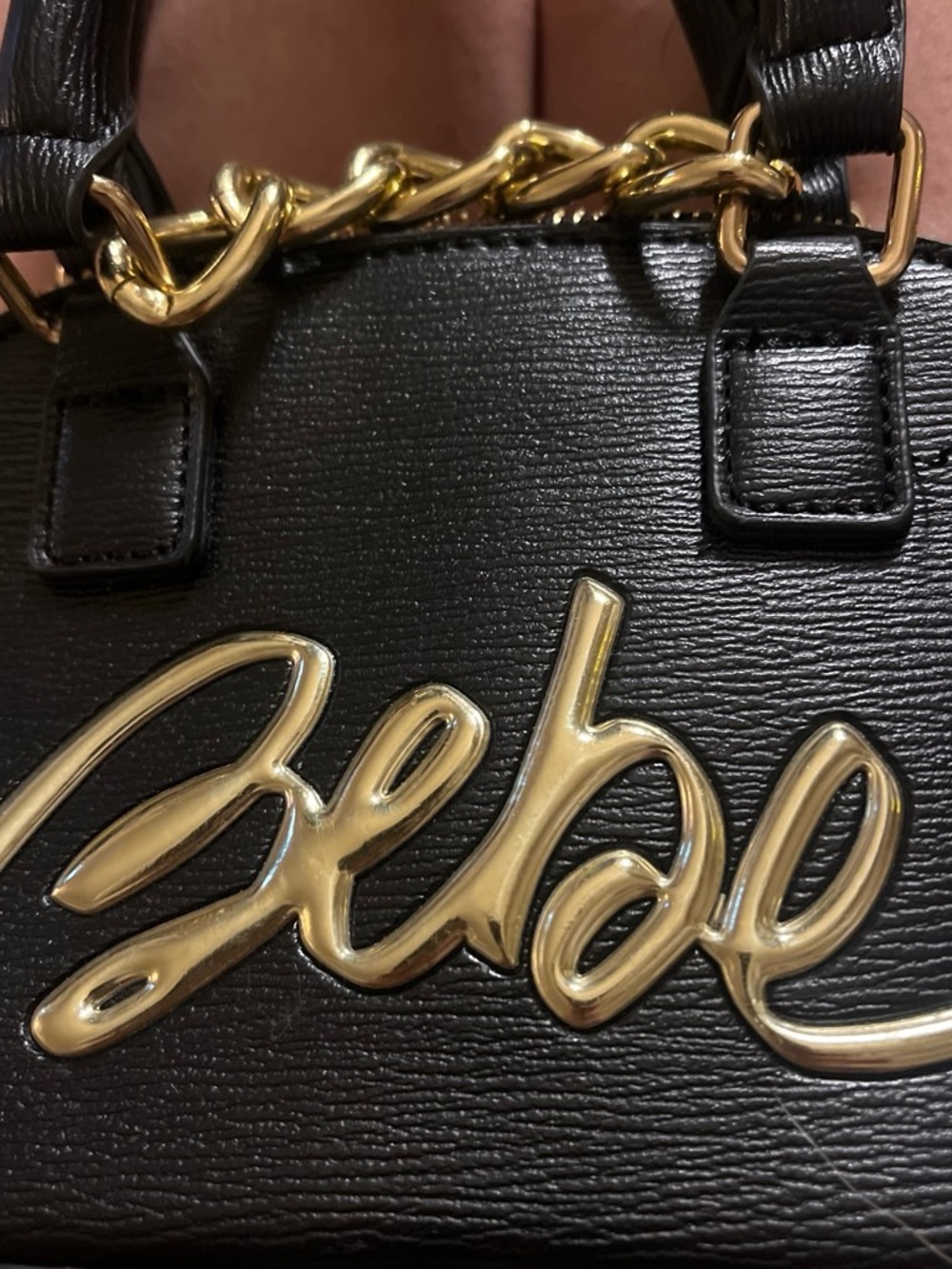 Super tiny Bebe Black Leatherette Handbag with Gold Script Accent. Adorable